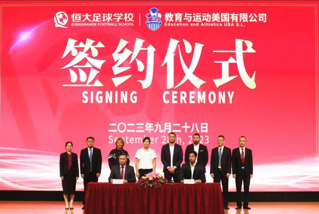 Kevin Zimmermann (on the right at the table) and Pablo Villoslada at the Signing Ceremony of the SIS Scholarship Agreement with Evergrande Football School